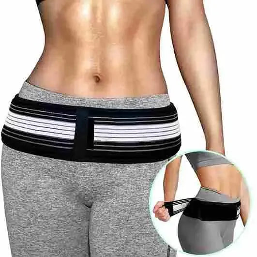Person wearing a black and white striped waist trainer with gray leggings on a white background.