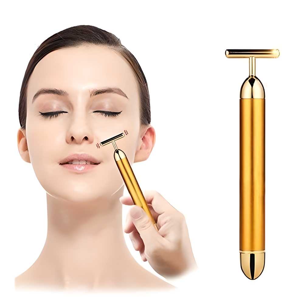 Gold facial roller device held by a hand with a woman using it on her face, on a white background.