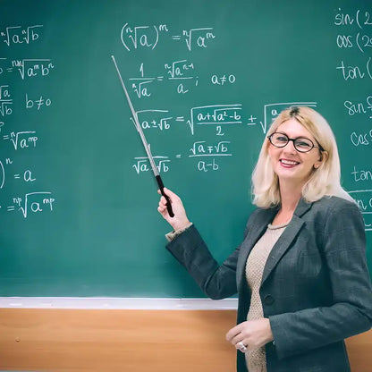 Teacher pointing to a chalkboard with mathematical equations