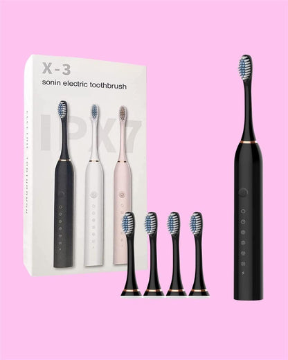 Black electric toothbrush with packaging and additional brush heads on a pink background