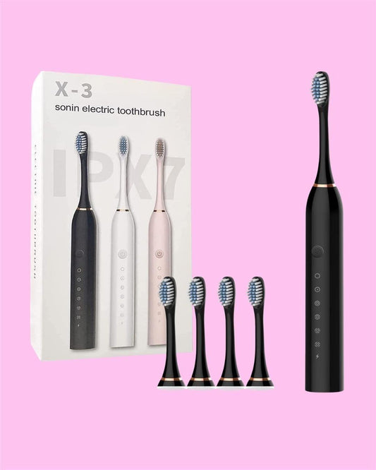 Black electric toothbrush with packaging and additional brush heads on a pink background