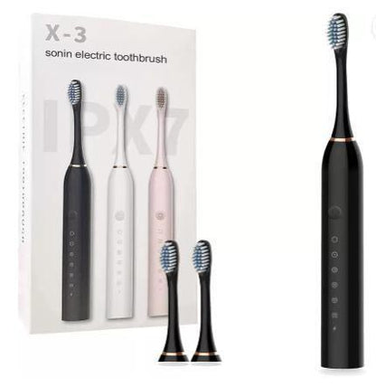 Black electric toothbrush with packaging and additional brush heads on a white background