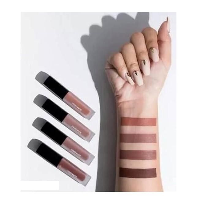 Five lip glosses with their swatches on a hand against a white background