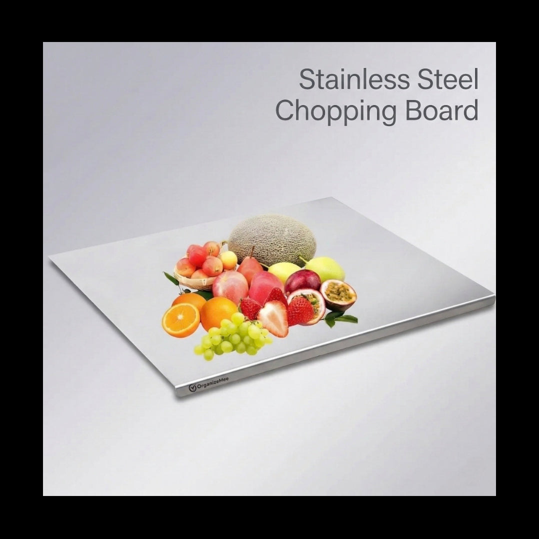 Stainless steel chopping board with a display of fruits on a light gray background