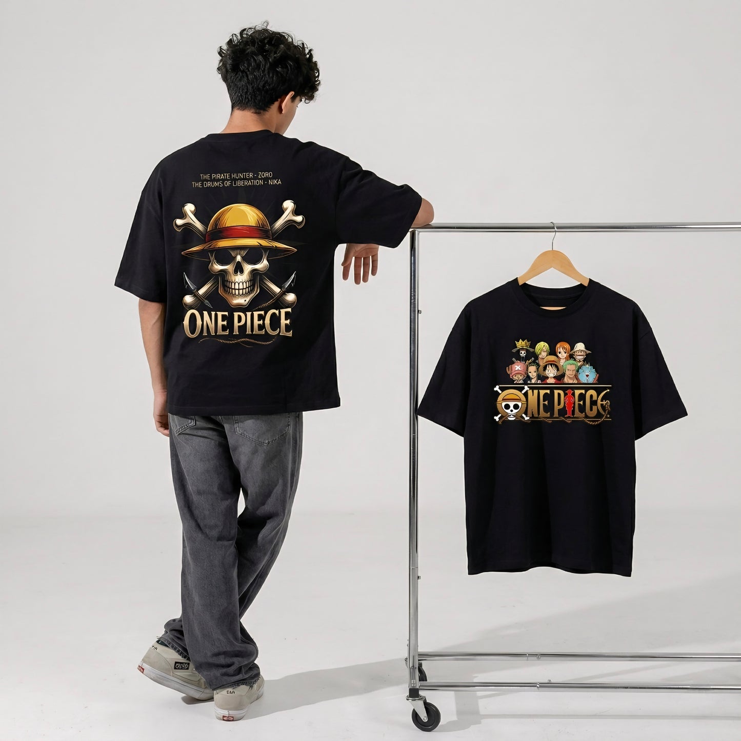 Person wearing a black 'One Piece' t-shirt with a graphic design, next to another 'One Piece' t-shirt on a rack.