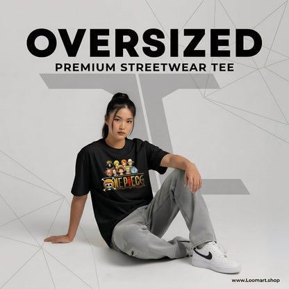 Person wearing a black oversized streetwear tee with graphics, sitting on a white floor.