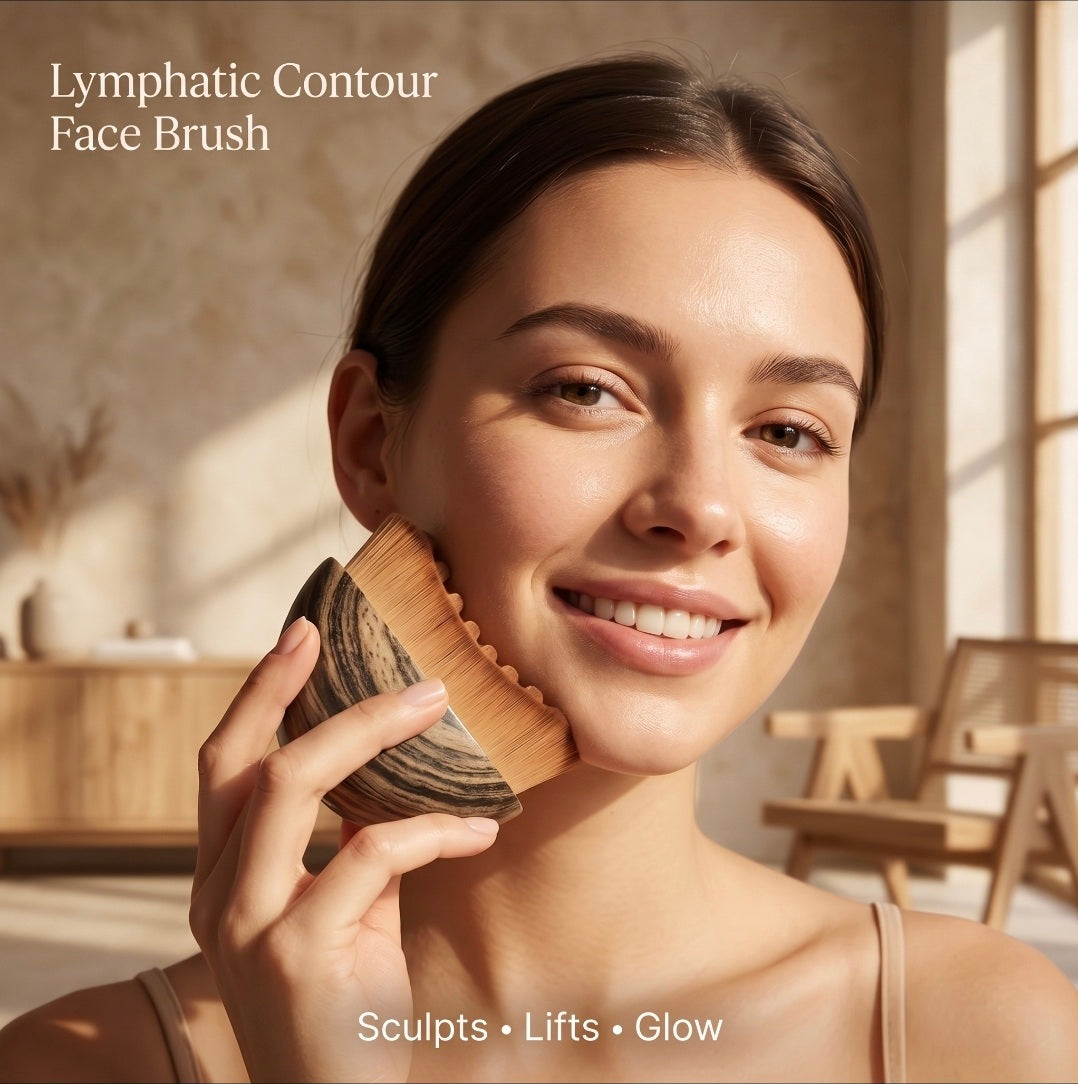 Woman using a Lymphatic Contour Face Brush in a warm, sunlit room.