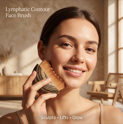 Woman using a Lymphatic Contour Face Brush in a warm, sunlit room.