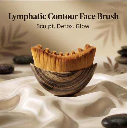 Lymphatic contour face brush with a wooden handle on a white fabric background.