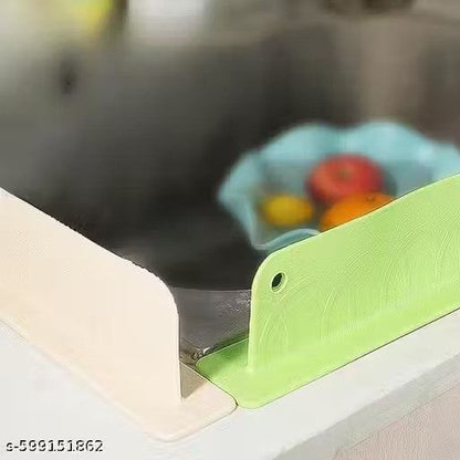 Green knife sharpener on a kitchen counter with a blurred background of fruits.