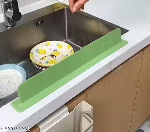 Green kitchen sink drain board with dishes in a sink