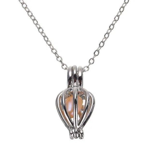 Silver heart-shaped pendant with a chain on a white background