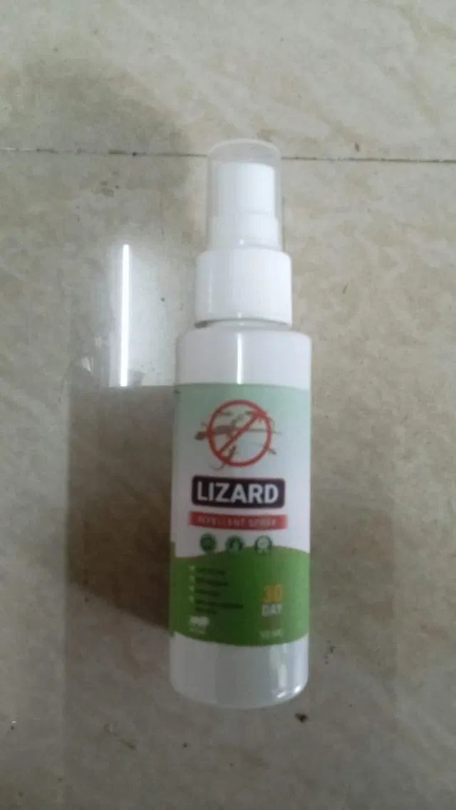 Spray bottle labeled 'Lizard' on a light-colored floor.