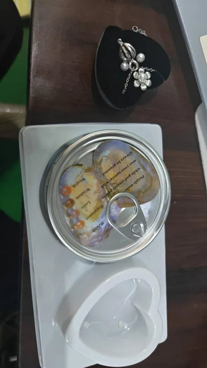 Heart-shaped container with a lid, containing small objects and text, on a wooden surface.