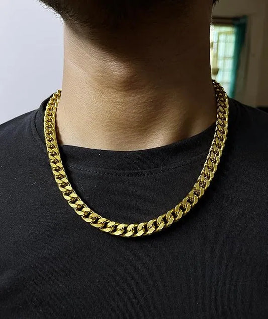 Gold chain necklace worn by a person on a black shirt